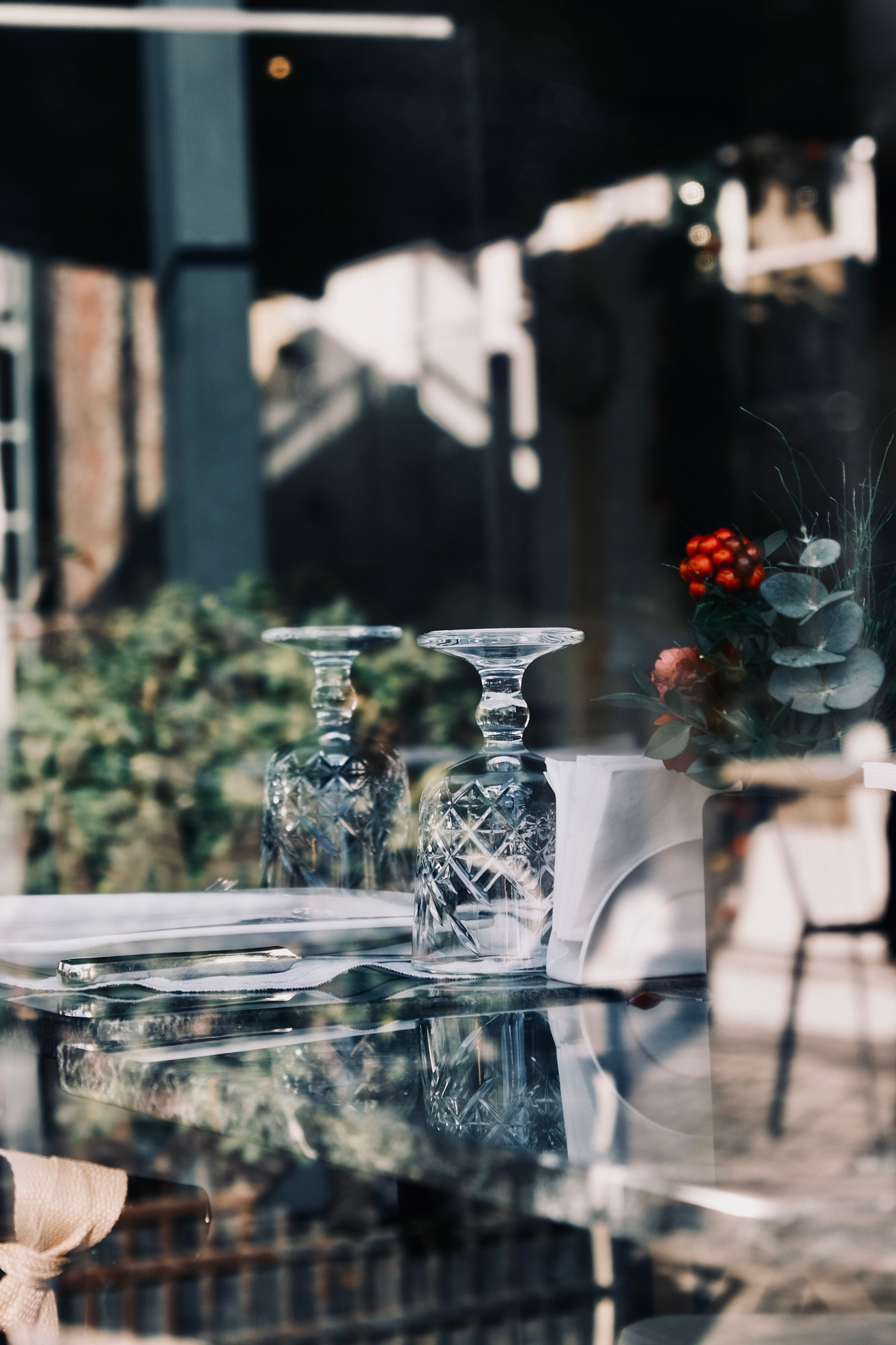 A set of hand-cut Bohemian crystal wine glasses with deep prismatic facets catching amber light